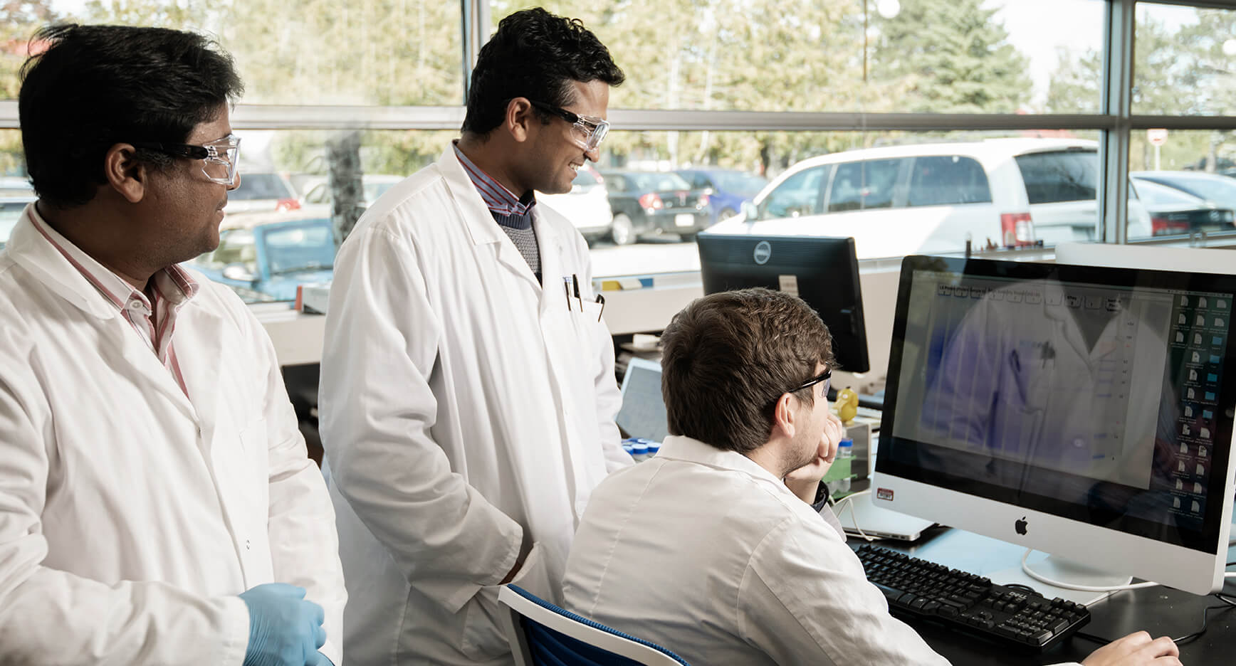 Noblegen scientists analyzing data on a computer in the lab